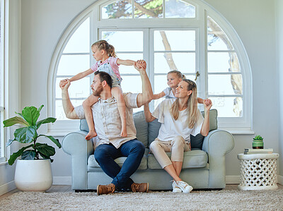 Buy stock photo Airplane, holding hands and piggyback by family in home with love, support and bonding while playing together. Flying, trust and kids with parents in a living room for morning, fun or shoulder games