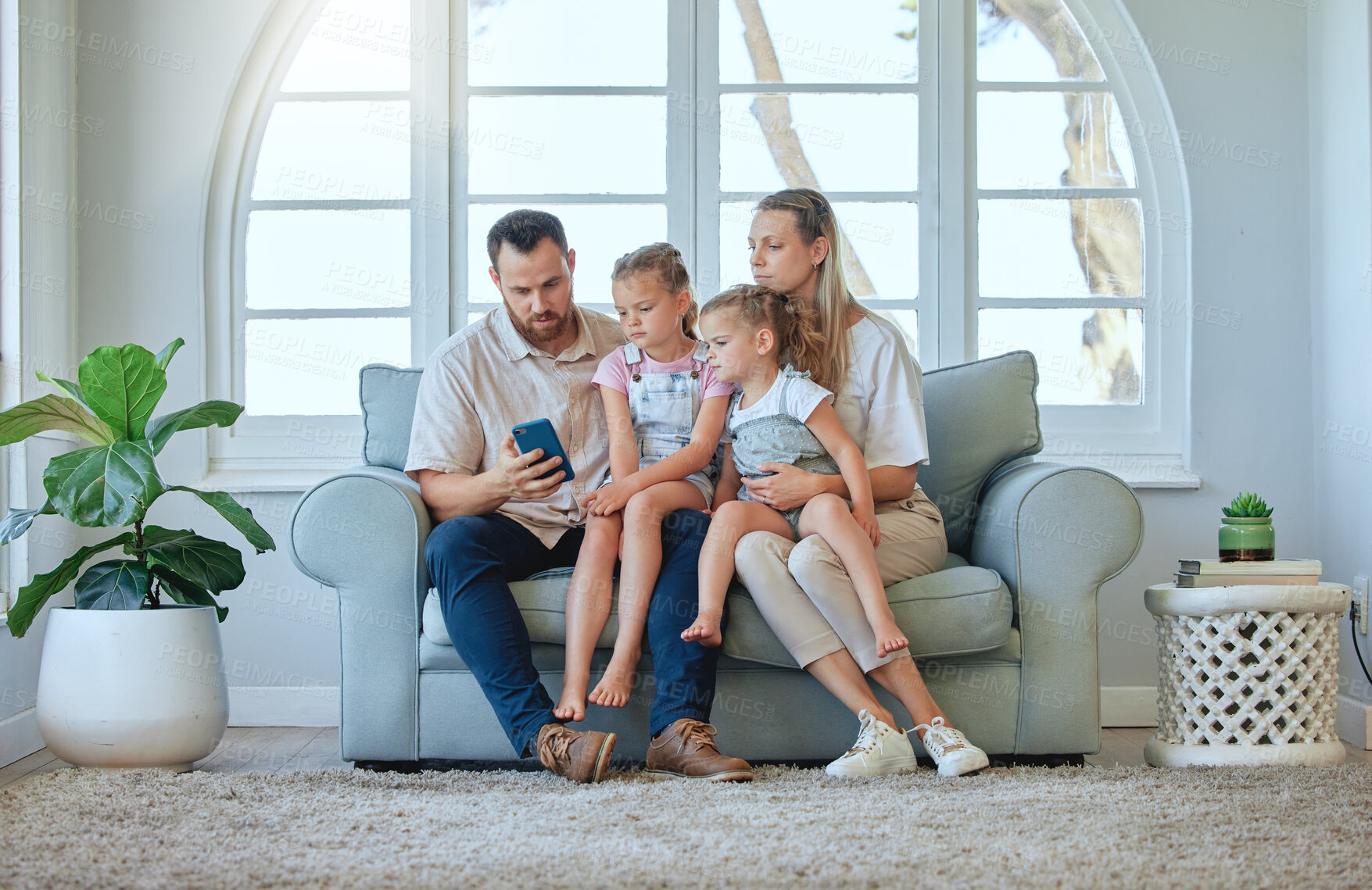 Buy stock photo Cellphone, family and together for reading, couch and online for message, living room and parents. Home, man and woman with kids, mobile and sofa for mother, father and children and connection