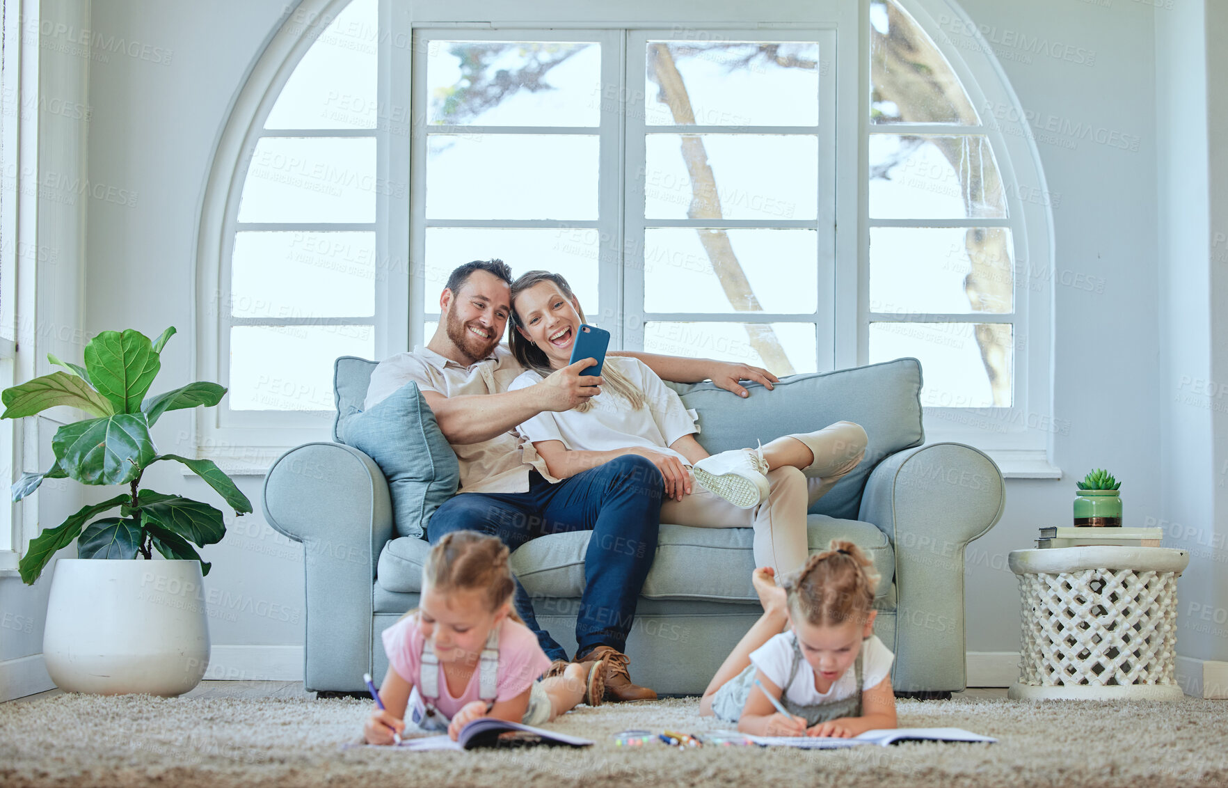Buy stock photo Cellphone, parents and together for laughing, couch and online for comedy, living room and kids. Home, man and woman with siblings, learning and sofa for mother, father and children and connection