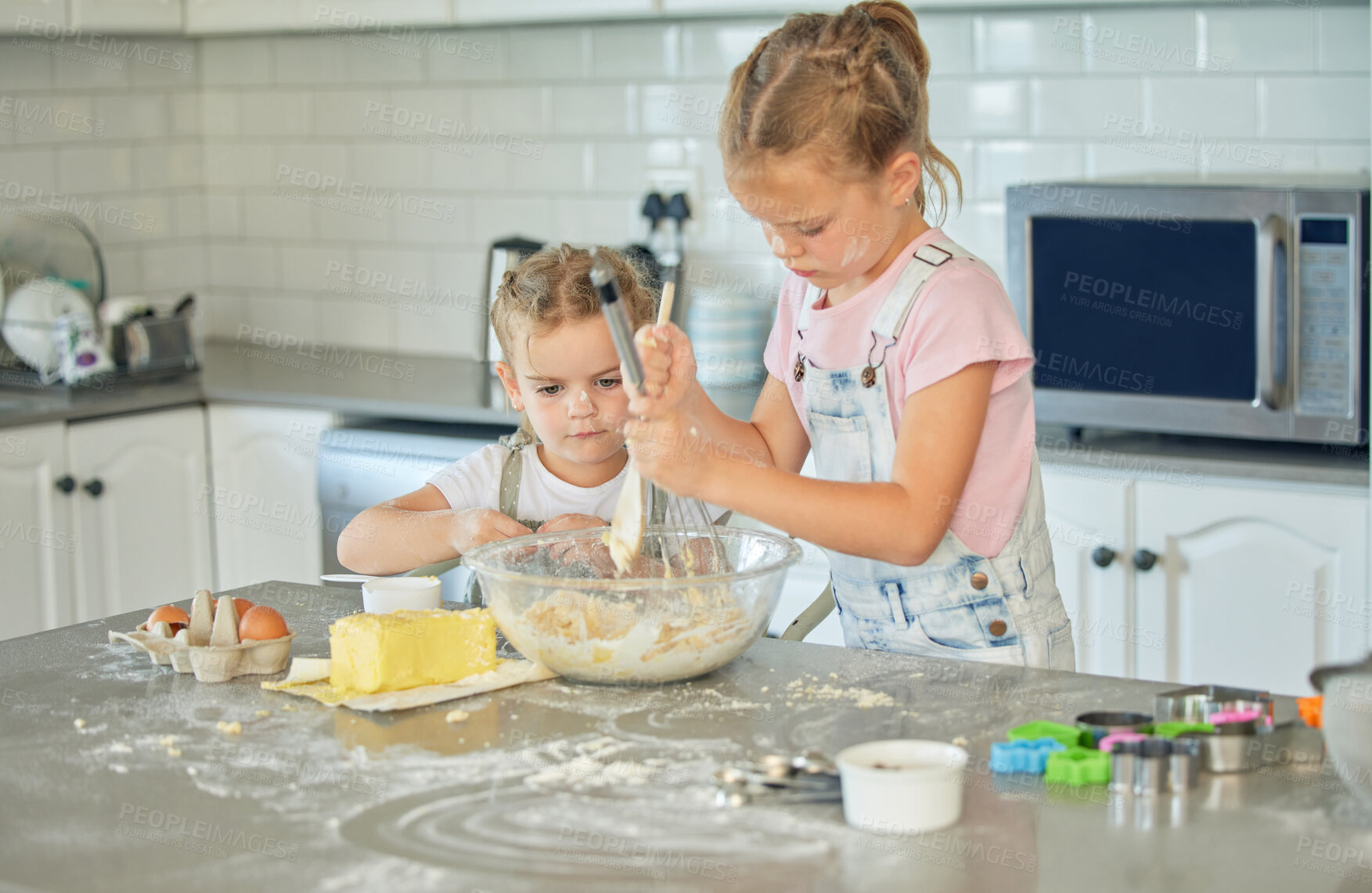 Buy stock photo Messy, girls and sisters in kitchen, baking and bonding together with activity, weekend break and fun. Home, ingredients and kids with dough, child development and learning with recipe and helping