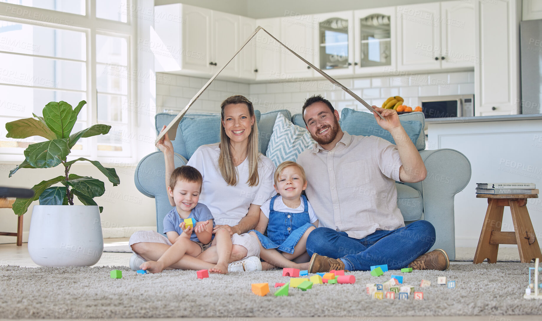 Buy stock photo Family, roof and cardboard in home for portrait, people and happy with love for house insurance with sofa for cover. Apartment, mortgage and living room with parents, safety and property security