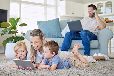 Buy stock photo Family, parents and kids with tablet on floor for playing, fun and bonding with digital education for child development. Mom, dad and watching in living room with online games or cartoon for learning