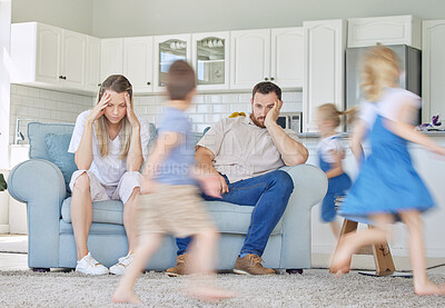 Buy stock photo Children, running and fast with tired parents in home, adhd and mental health with busy siblings in apartment. Living room, people and burnout with headache, sofa and motion blur in chaotic house