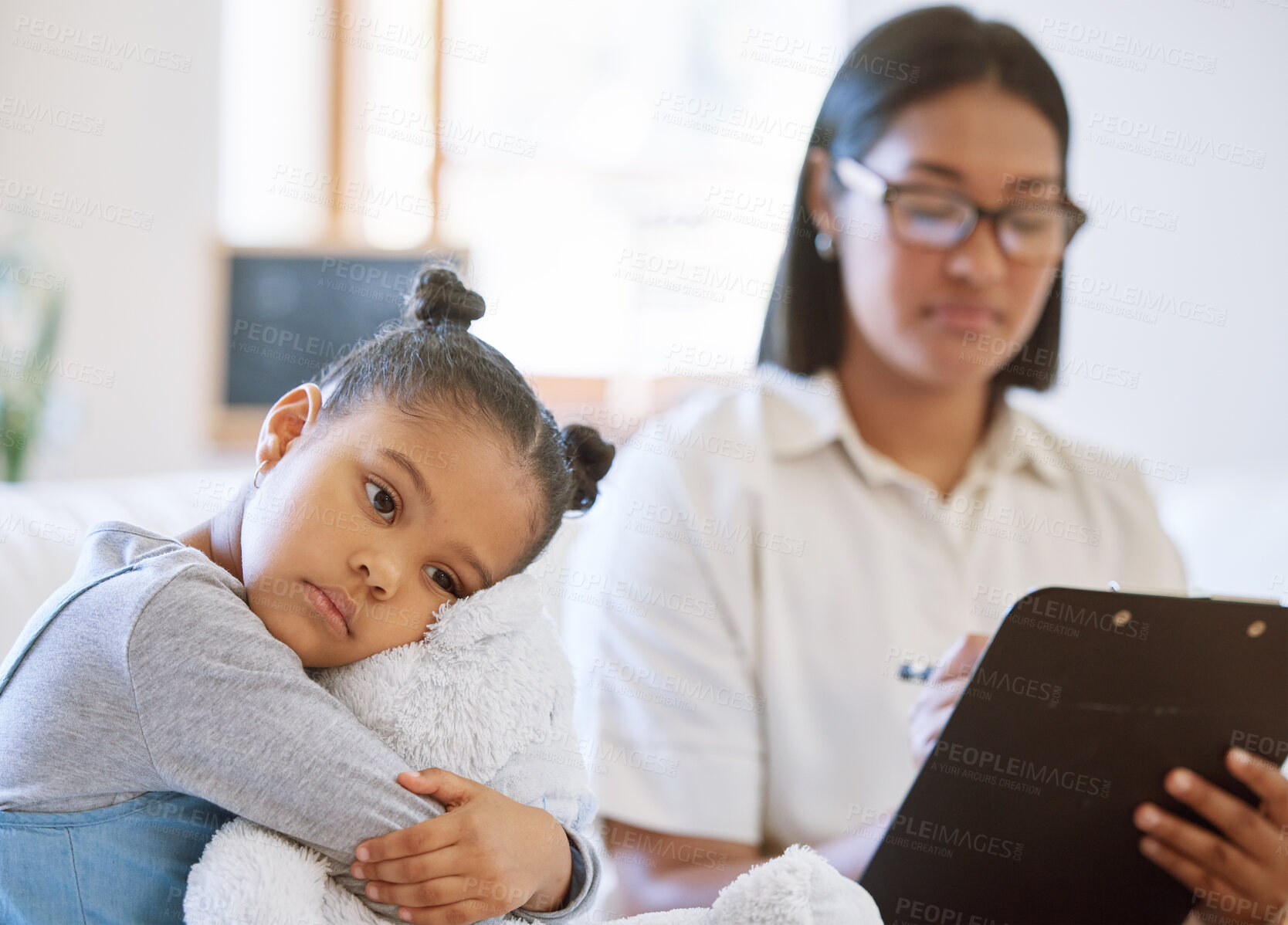 Buy stock photo Depressed child, sad and hug teddy bear with woman psychologist and counselling notes for mental health in clinic. Young girl or orphan, toy animal and stress for adoption application with therapist