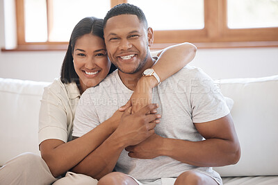 Buy stock photo Smile, portrait and couple hug on a sofa with love, trust and bonding in their home together. Happy, face and people embrace while holding hands in living room with support, care or romance in house