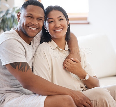 Buy stock photo Happy, portrait and couple hug on a sofa with love, trust and bonding in their home together. Face, smile and people embrace while holding hands in living room with support, care or romance in house