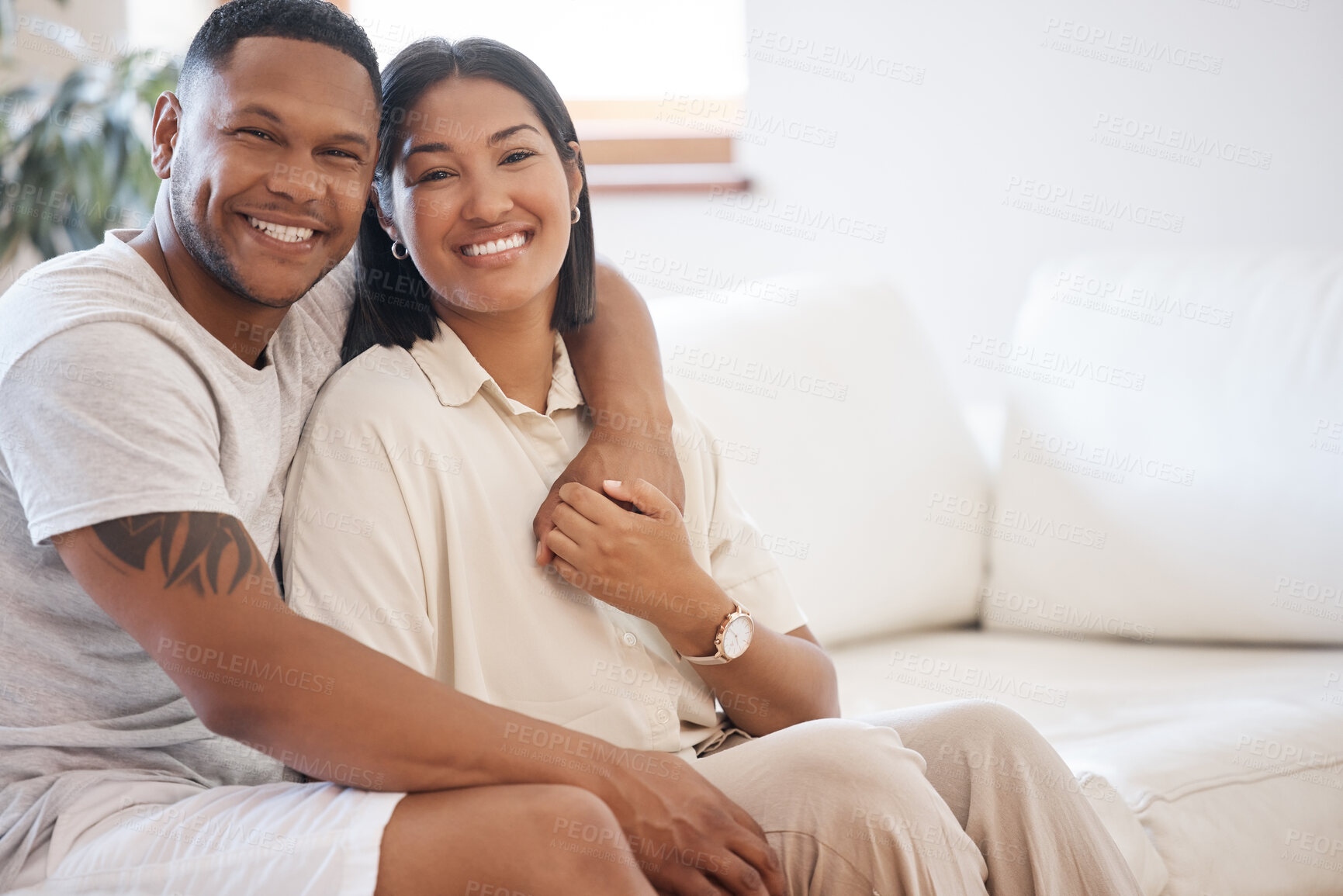 Buy stock photo Love, portrait and happy couple hug on sofa with care, trust or bonding in their home together. Face, smile or people embrace while holding hands in living room with support, date or romance in house