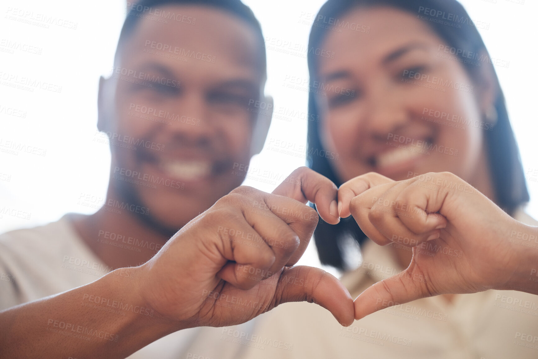 Buy stock photo Heart hands, portrait and happy couple in house with gesture for love, support and thank you sign. Finger, frame or people blur at home with kindness emoji, romance or valentines day, bonding or care