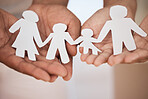 Closeup of a couples hands holding paper cutout of a perfect family. Symbol of home cover, insurance, health, adoption, custody, law, safety, security protection, foster, adoption family home concept 