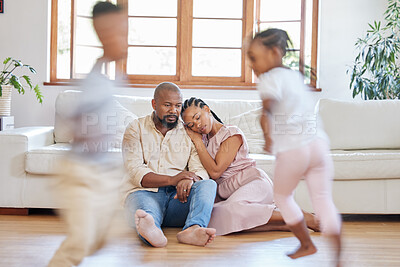 Buy stock photo Fatigue, parents and children running in home for stress, burnout and frustrated on floor. Adhd, movement and black family in lounge and headache or tired from kids with energy or motion blur