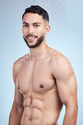 Buy stock photo Portrait, man and shower water for skincare with smile, body and hygiene wellness for skin glow in studio. Male person, liquid drops and cleaning process for grooming with health by blue background