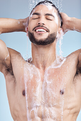 Buy stock photo Shower, relax and man with soap, hair care and grooming with fresh morning bathroom routine on blue background. Health, wellness and male person in water for cleaning, washing and shampoo in studio.