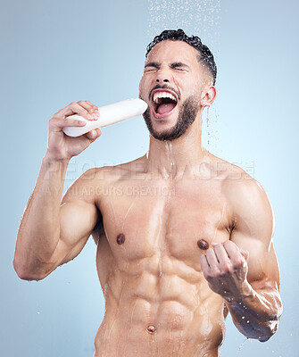 Buy stock photo Shower, singing and man with bottle for body, grooming, and fun morning routine on blue background. Health, wellness or happy male person in water for cleaning, washing and skincare hygiene in studio