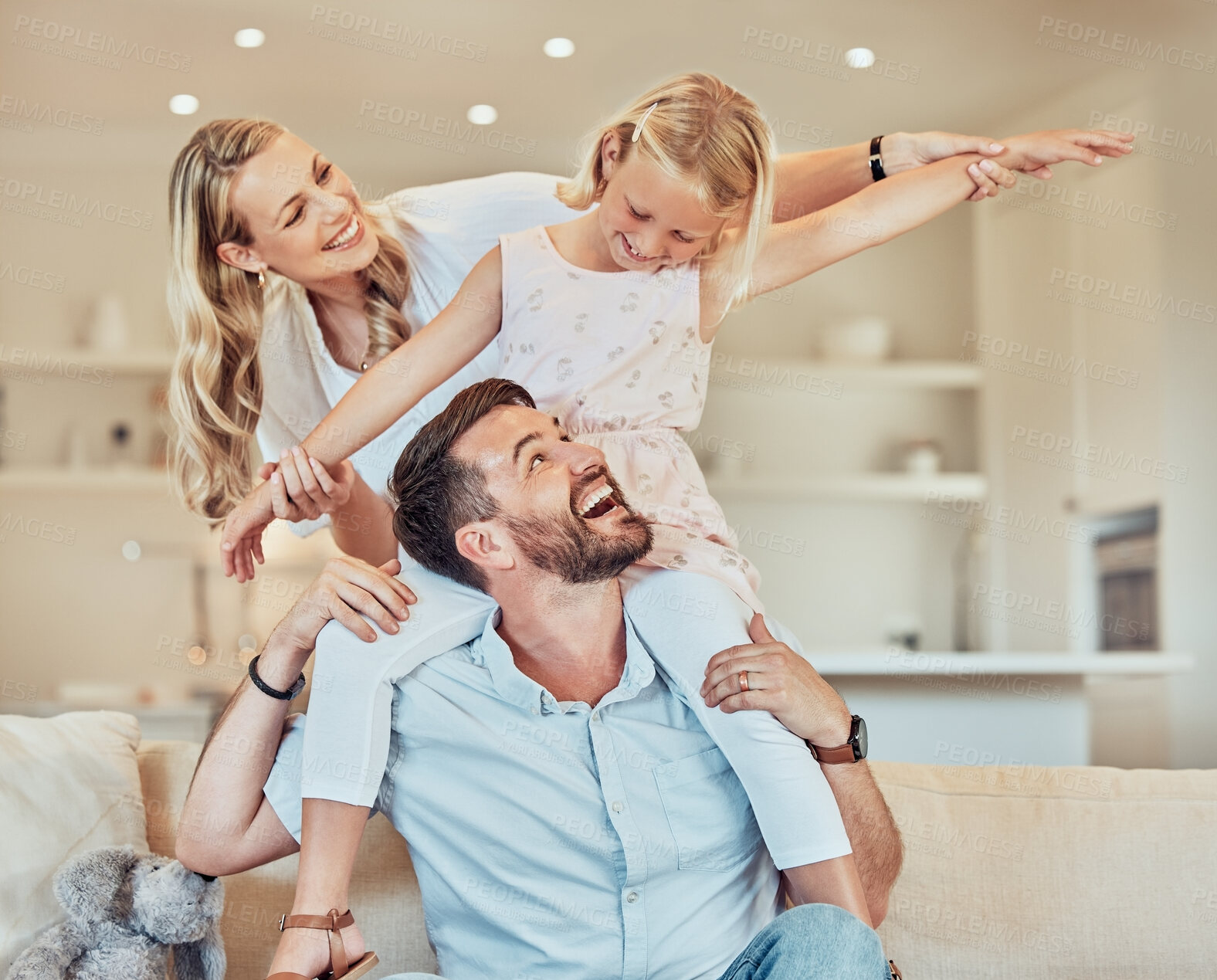 Buy stock photo Happy, piggyback and family in living room for love, airplane game and play together on weekend. Mom, dad and girl child on sofa for happiness and laughing in home with comedy or development and fun