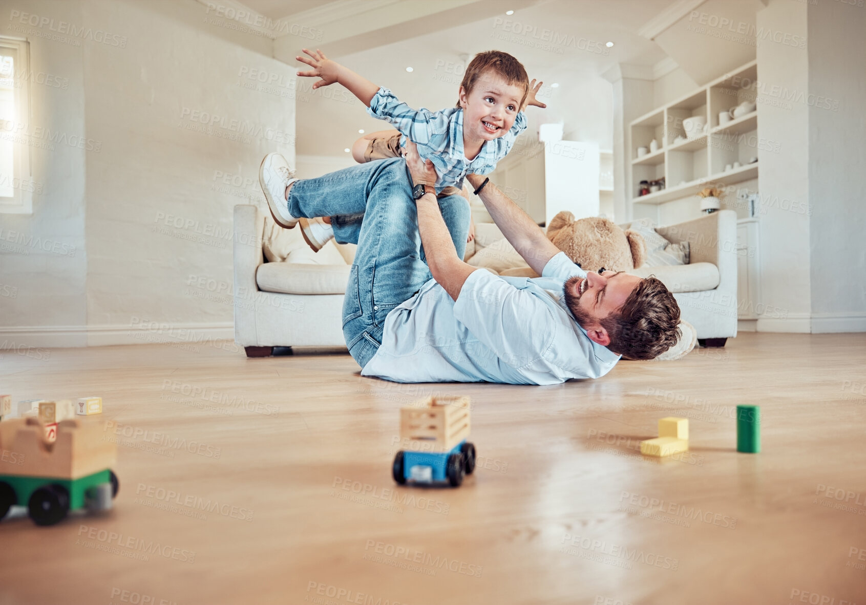 Buy stock photo Boy, dad and excited for airplane game in home with bonding together, parent care and happiness. Lounge floor, father and balance kid for flying with love relationship, energy and support for fantasy