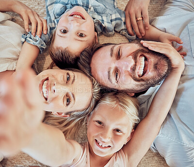 Buy stock photo Top view smile, selfie portrait and family on floor for relationship bonding, memory and social media in home. Love, man and woman with children for profile picture, live stream together and support