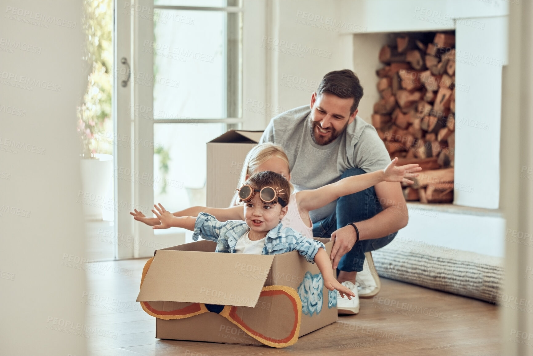 Buy stock photo Dad, children and home with cardboard airplane for playing, happiness and bonding in new family house. Father, siblings and push box in living room for fun or energy, growth and development with kids