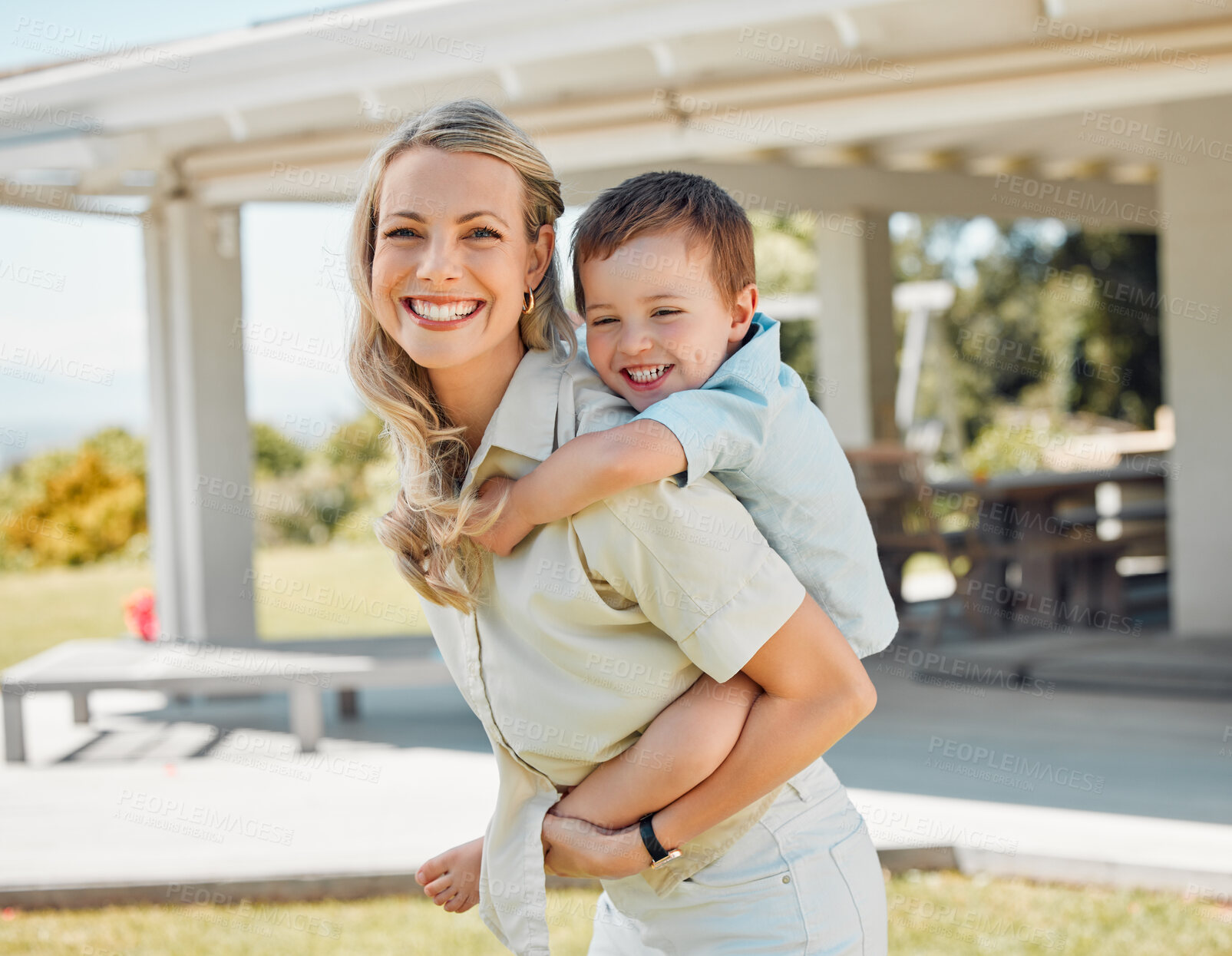 Buy stock photo Woman, happy and piggyback son outdoor for love, bonding hug and playful interaction of support at house. Smile, mother and child with embrace for family security in backyard for childhood memory