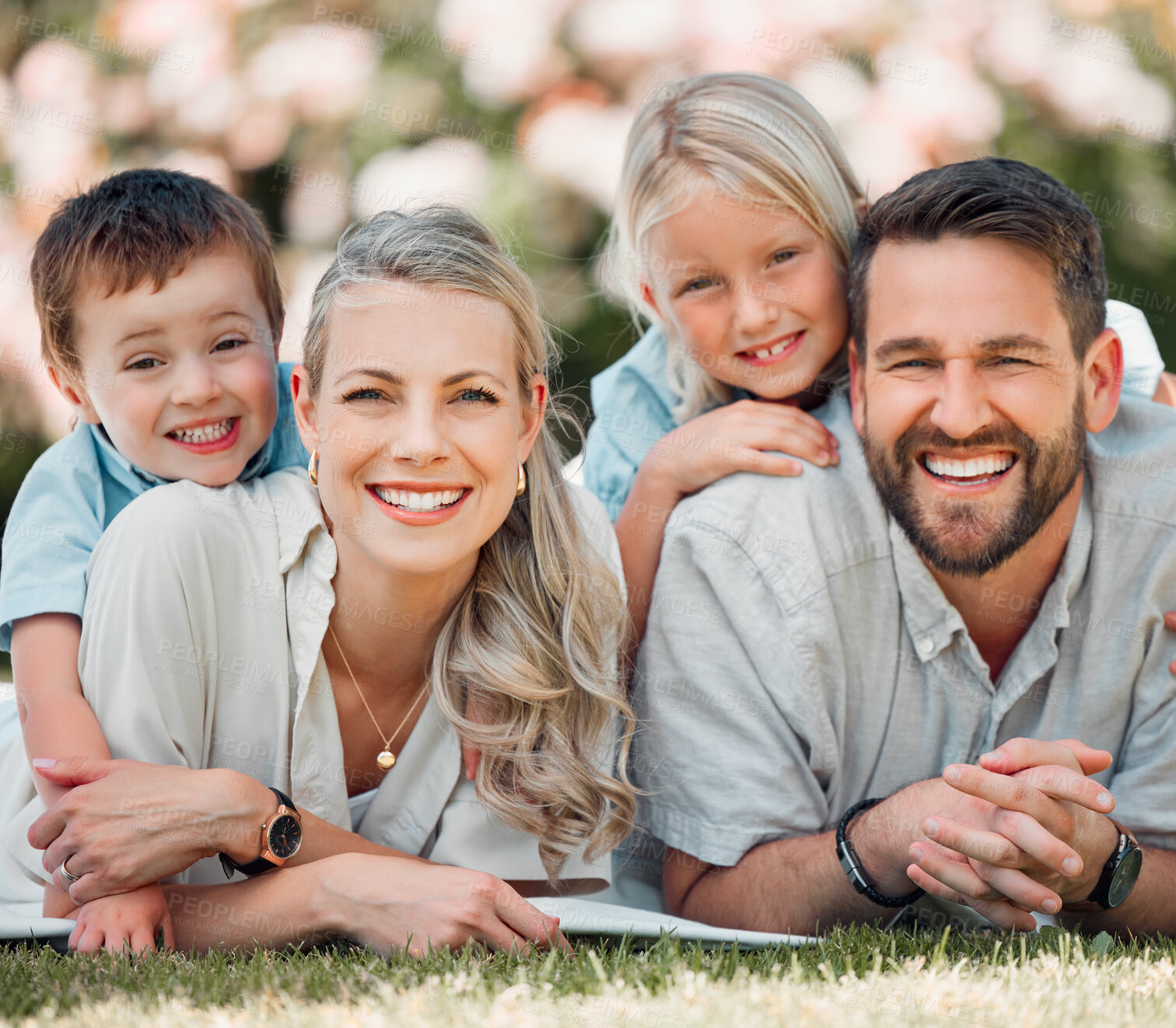 Buy stock photo Portrait, family and grass for picnic, smile and outdoor to relax in summer, love and bonding in break. Parents, woman and man with children, happy and weekend for connecting with young kids in park