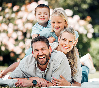 Buy stock photo Portrait, family and grass for picnic, fun and outdoor to relax in summer, love and bonding in break. Parents, woman and man with children, happy and weekend for connecting with young kids in park