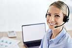 Portrait of young caucasian female call centre agent talking on headset while working on computer in an office. Confident and happy businesswoman consulting and operating a helpdesk for customer sales and service support