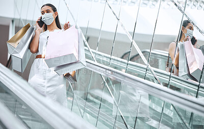 Buy stock photo Woman, shopping bags and mask for protection in pandemic as consumer in mall for fashion, style or trend. Female person, mobile and phone call as stylist, influencer or blogger in retail or store