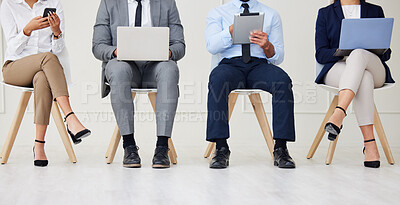 Buy stock photo Technology, job interview and legs of business people waiting in queue for recruitment process in office. Human resources, meeting and hiring candidates with phone, laptop and tablet for vacancy.