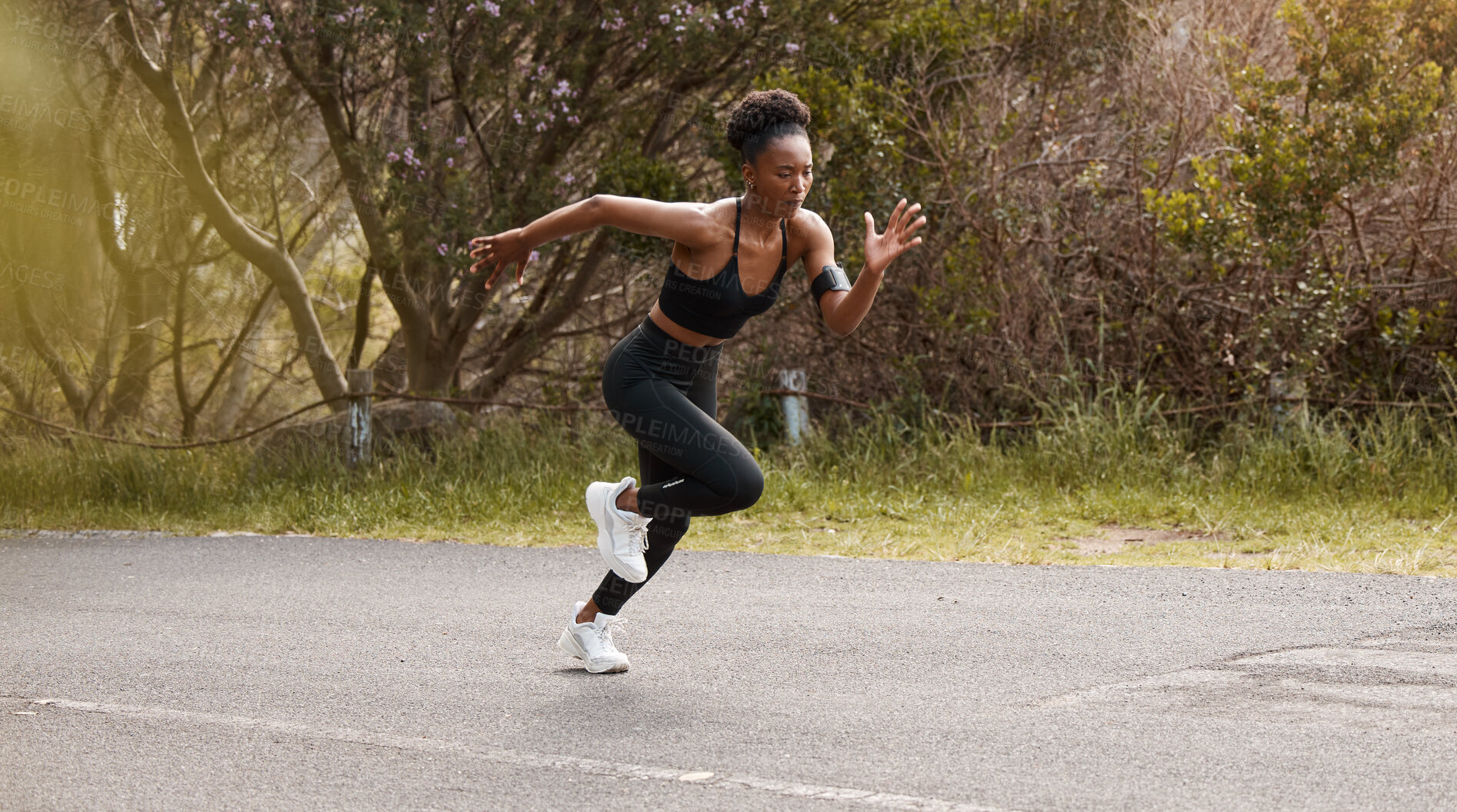 Buy stock photo Fitness, go and black woman running in a road for speed training, action or body performance in nature. Start, wellness and African girl runner in a street for marathon, practice or cardio routine