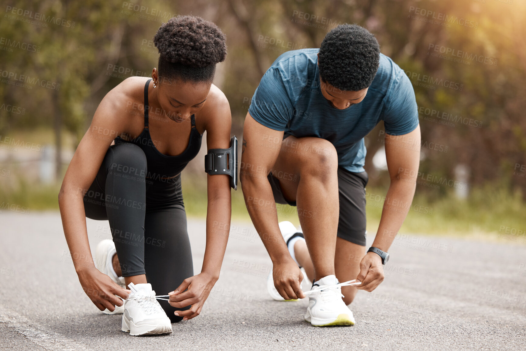Buy stock photo Road, runner and couple tie shoes before workout for cardio, running or marathon training in morning. Fitness, hands and black people for prepare, fasten sneakers or ready to start jog outdoor