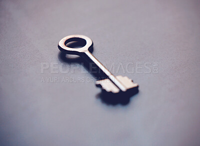 Buy stock photo Key, security and investment with metal on grey background, new home and opportunity for real estate in studio. Unlock, future and entry tool for potential growth, space and property or house access
