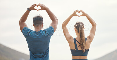 Buy stock photo Couple, back and heart hands in outdoor for fitness or love for training, healthcare and wellness or wellbeing. Man, woman and together with sign for expression of support, motivation and marathon.