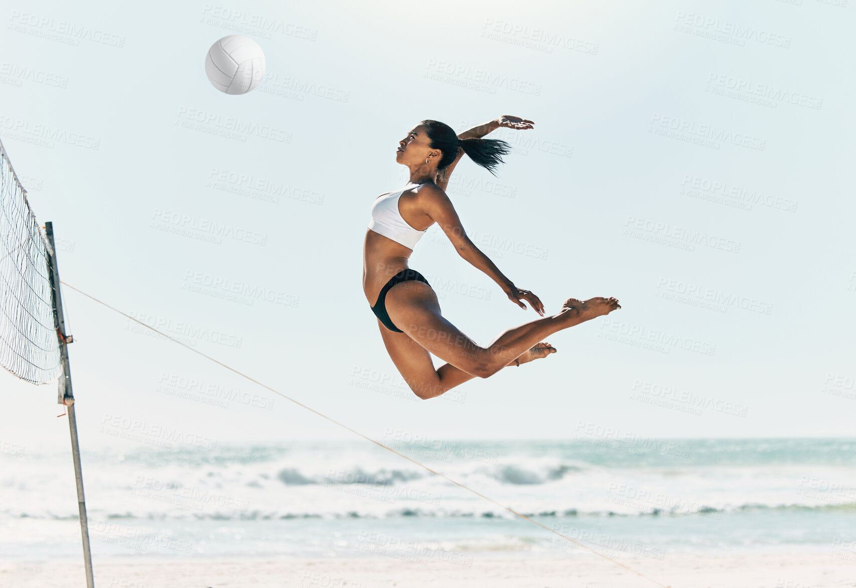 Buy stock photo Sports woman jump at volleyball beach summer outdoor competition game on ocean or sea sand playing to win. Healthy, fitness and training agile girl or young athlete ready hit ball over net in match