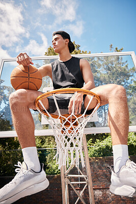 Buy stock photo Basketball, sports and man on basket with ball for fitness, exercise and training workout at a community park with sports sneakers. Basketball player, urban court and game with male athlete thinking