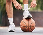 Basketball, athlete with shoelace, shoes and sport on basketball court outdoor, fitness and exercise motivation. Man, basketball player and ready for game, training and active with cardio and sports.