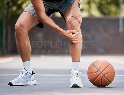 Buy stock photo Pain, basketball and man with knee injury standing on outdoor court, holding leg. Sports, fitness and athlete with joint pain, injured and hurt in training, workout and game on basketball court