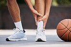 Legs, pain and sport injury with basketball and athlete on basketball court outdoor with emergency and fitness. Basketball player hurt, shoes and exercise with accident during match and workout.