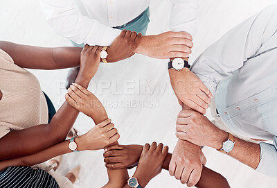 Buy stock photo Top view, business people hands or holding arm in collaboration, office workshop or solidarity for teamwork diversity, community or motivation. Men, women or creative support wrist for target goals