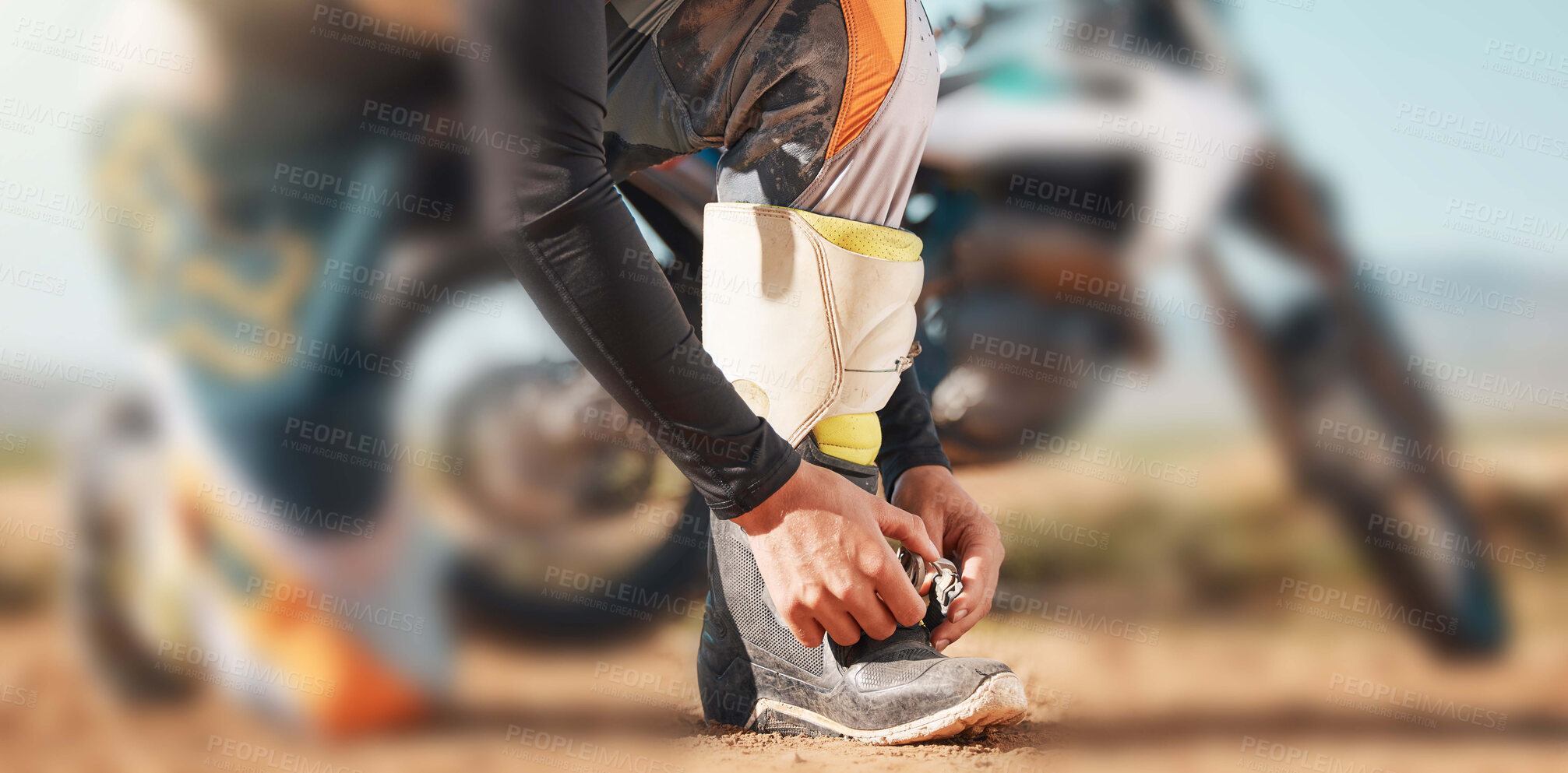 Buy stock photo Start, motorcycle and man tying laces in nature for adventure, holiday and race in the countryside. Road, travel and biker ready with shoes for a journey on a motorbike on a dirt road for freedom