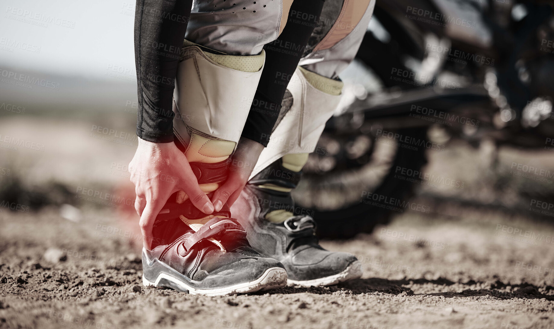 Buy stock photo Ankle, injury and motorcycle with the hands of a man holding his joint in pain while outdoor for a race. Sports, training or anatomy with a male athlete suffering an accident on a ride for recreation