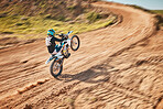 Motorcycle athlete, dirtbike and motion blur for sports on sand trail for freedom. Driver, cycling and offroad competition, motorbike performance and adventure course for fast action, speed and risk 