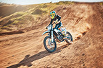 Sport, motorcycle and person driving in a desert for fitness, training and extreme sports in nature. Biking, motorbike and athletic practice stunt, speed and adrenaline in sand, exercise and freedom