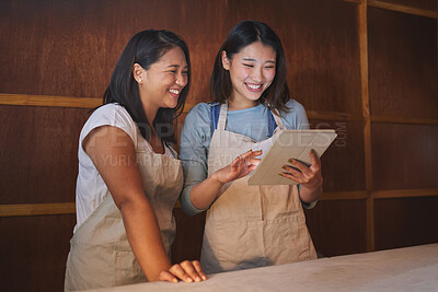 Buy stock photo Restaurant, tablet and happy asian women at counter together checking sales, booking or menu for small business. Social media, food review and startup cafe owner with waitress scroll on digital app.