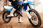 Motorcycle, person legs and sports in forest with training for competition, nature with action and helmet. Extreme, adrenaline and exercise, athlete and transport with dirt bike, freedom and travel