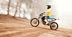 Motorcycle, speed and uphill with a sports man on space in the forest for dirt biking. Bike, fitness and power with a person driving fast on an incline or off road course for freedom or performance