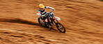 Bike, dust and motion blur with a sports man on space in the desert for dirt biking. Motorcycle, exercise and power with a person driving fast on sand or off road course for freedom or performance