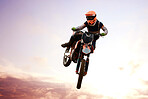 Motorcycle, person and jump for training or sports with fitness, balance or challenge in nature on mock up space. Bike, freedom and adventure for competition, exercise or talent with safety gear
