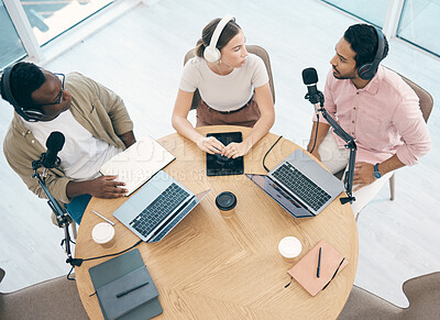 Buy stock photo Laptop, podcast or broadcast with a content creator team in their office from above for streaming or recording. Radio, microphone and influencer friends in the studio together on a creative platform