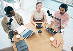 Radio, technology or broadcast with a content creator team in the office from above for streaming or recording. Podcast, microphone and influencer friends in a studio together on a creative platform