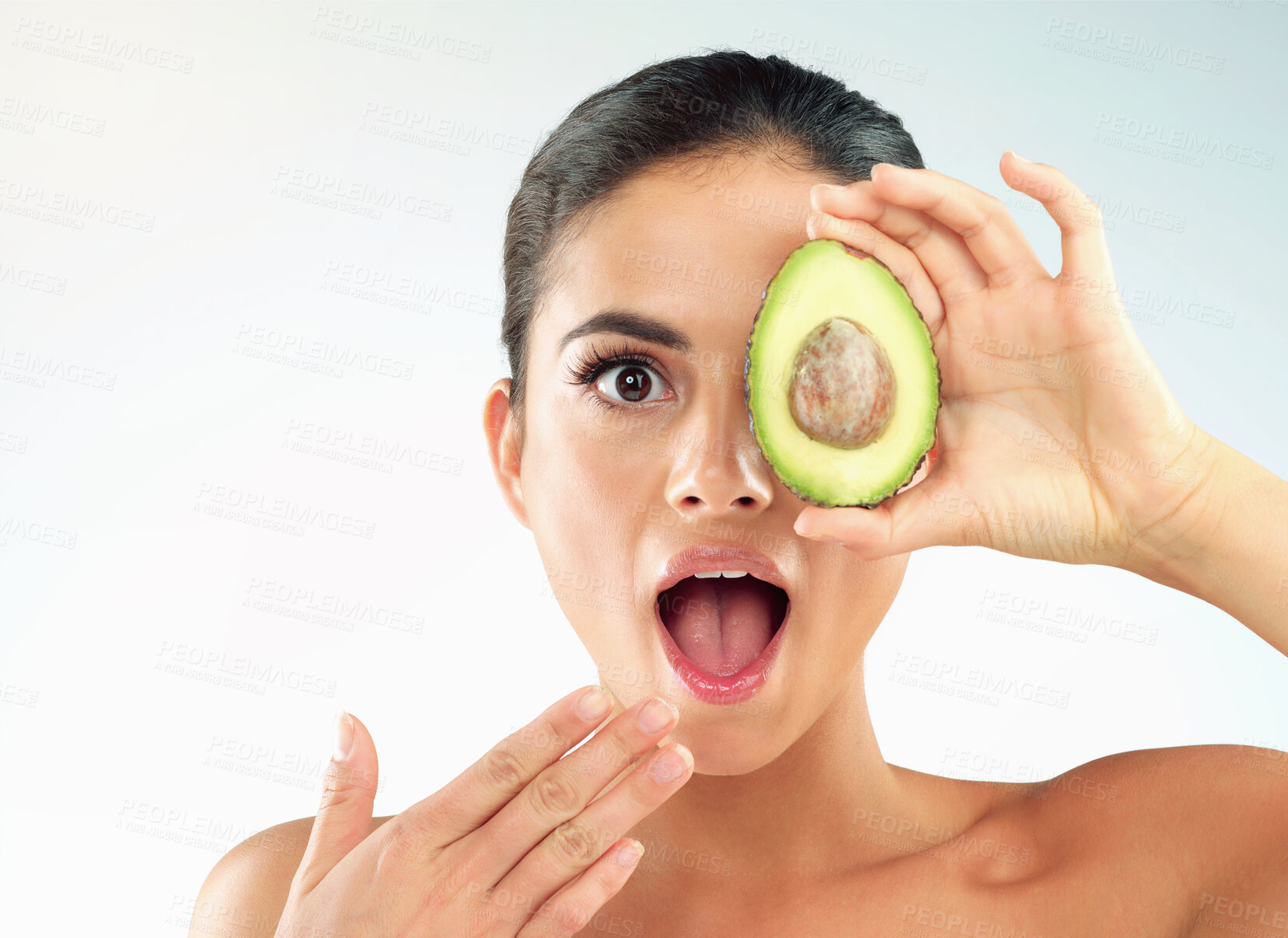 Buy stock photo Woman, portrait and avocado for skincare in studio with wow, surprised and shocked for beauty benefits. Model, girl and mockup with fruit for natural cosmetics and antioxidants on white background