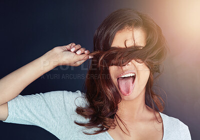 Buy stock photo Woman, hair and hiding on studio background for beauty, cosmetics and healthy growth or textures. Female person, tongue out and humor for haircare, keratin treatment and comedy for dermatology curls